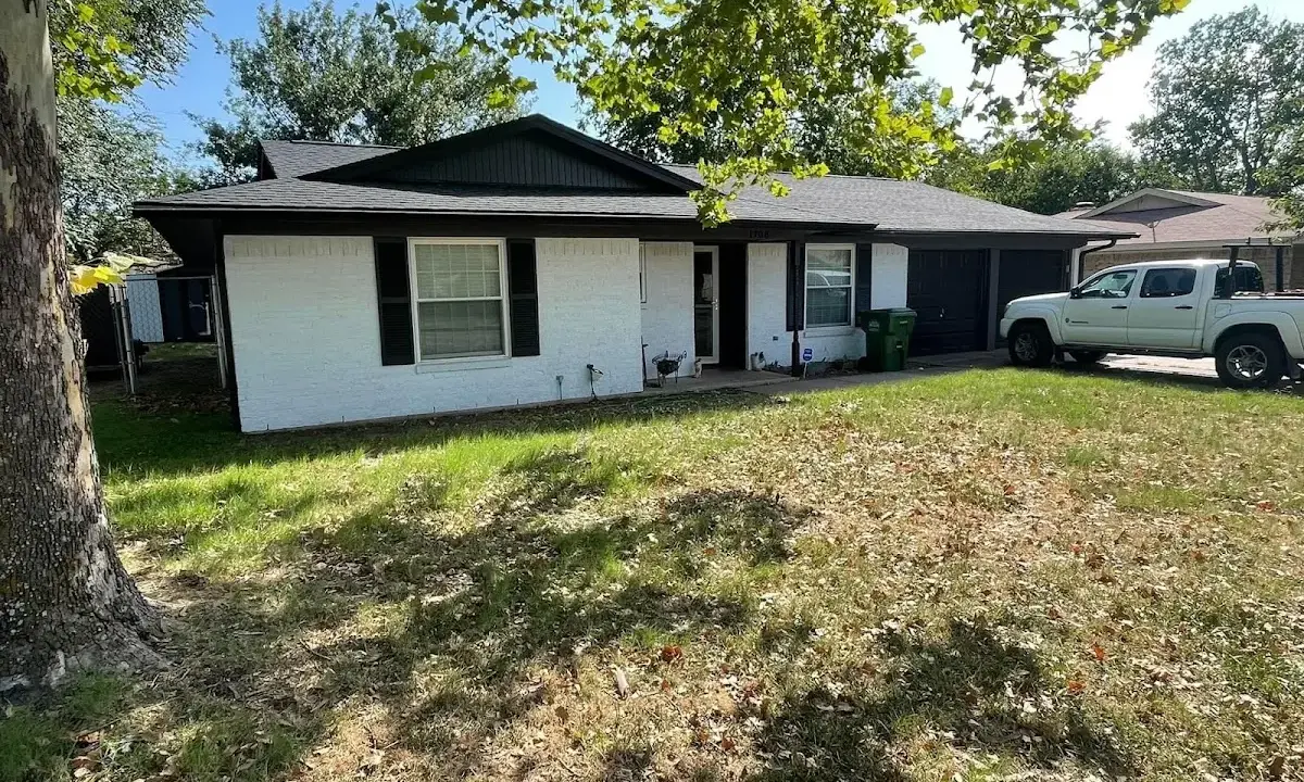 Professional roofing crew working on a residential roof in Prospect Park